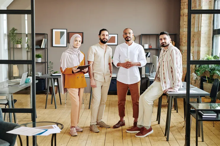 Colleagues standing together in a bright office